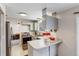 Modern kitchen with gray cabinets and breakfast bar at 3161 S Kalispell St, Aurora, CO 80013