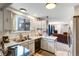 Kitchen area featuring a sink, window, and adjoining Gathering room, creating a cohesive and welcoming living space at 3161 S Kalispell St, Aurora, CO 80013