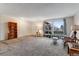 Spacious living room with neutral tones, large window, and carpet flooring provides a comfortable and inviting atmosphere at 3161 S Kalispell St, Aurora, CO 80013