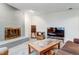 Spacious living room featuring a fireplace, neutral carpet, and a large television for entertainment at 3161 S Kalispell St, Aurora, CO 80013