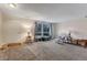 Bright and airy living room featuring neutral walls, carpet flooring, and a large window with natural light at 3161 S Kalispell St, Aurora, CO 80013