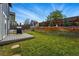 Large, fenced backyard with multi-level entertaining space, including a deck, shed, and a tiered garden at 3593 S Gibralter Cir, Aurora, CO 80013