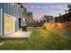 Fenced backyard with lush lawn, wood deck, grill, shed and tiered garden beds lit with string lights at 3593 S Gibralter Cir, Aurora, CO 80013