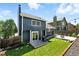 Landscaped backyard with patio, grill, green grass, and string lights for outdoor enjoyment at 3593 S Gibralter Cir, Aurora, CO 80013