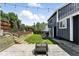 Landscaped backyard with patio, fire pit, and retaining wall, offering a serene outdoor space at 3593 S Gibralter Cir, Aurora, CO 80013