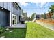 Expansive backyard features green grass, a wooden retaining wall, and a storage shed at 3593 S Gibralter Cir, Aurora, CO 80013