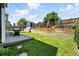 Green backyard with wooden retaining wall, storage shed, and barbecue grill on deck at 3593 S Gibralter Cir, Aurora, CO 80013