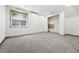 Neutral basement space with carpet and a window bringing in light to the interior at 3593 S Gibralter Cir, Aurora, CO 80013