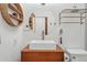 Bright bathroom with modern square sink, stylish fixtures, and wood vanity at 3593 S Gibralter Cir, Aurora, CO 80013