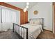 Bedroom with accent wall, globe lighting fixture, and queen bed at 3593 S Gibralter Cir, Aurora, CO 80013