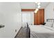Bedroom with globe lighting fixture and accent wall at 3593 S Gibralter Cir, Aurora, CO 80013