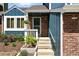 Close-up shot of the entryway, showcasing the home's brick facade, tidy landscaping, and welcoming front porch at 3593 S Gibralter Cir, Aurora, CO 80013