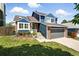 Charming two-story home with brick and blue siding, complemented by a well-manicured lawn and a two-car garage at 3593 S Gibralter Cir, Aurora, CO 80013