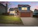 Charming two-story home boasts a manicured lawn, brick accents, and an inviting facade under a beautiful sky at 3593 S Gibralter Cir, Aurora, CO 80013