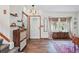 Inviting foyer features wood floors, stylish decor, and a window with patterned curtains for natural light at 3593 S Gibralter Cir, Aurora, CO 80013