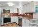 Well-lit kitchen with stainless steel appliances, granite countertops, and ample cabinet space at 3593 S Gibralter Cir, Aurora, CO 80013