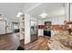 Bright kitchen featuring stainless steel appliances, granite countertops, and view to living area at 3593 S Gibralter Cir, Aurora, CO 80013
