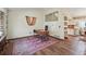 Home office features hardwood floors, a modern desk, and unique artwork on the walls, offering a creative workspace at 3593 S Gibralter Cir, Aurora, CO 80013