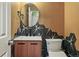 Stylish powder room with unique geometric tile backsplash, round mirror, and modern fixtures at 3593 S Gibralter Cir, Aurora, CO 80013