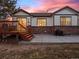 Lovely backyard with a wooden deck and a stone patio, ideal for outdoor entertaining at 8099 Sabino Ln, Castle Rock, CO 80108