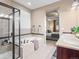 A bright bathroom featuring a soaking tub, tiled shower, vanity, and neutral colors, connecting to the Primary bedroom at 8099 Sabino Ln, Castle Rock, CO 80108