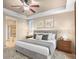 Comfortable bedroom with neutral walls, a gray bed, carpet, and windows for natural light, showcasing a peaceful retreat at 8099 Sabino Ln, Castle Rock, CO 80108