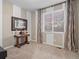 Serene bedroom featuring a large window with decorative curtains, wood table and neutral carpet at 8099 Sabino Ln, Castle Rock, CO 80108