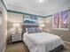 A charming bedroom with a blue accent stripe, complemented by stylish bedside tables and bright natural light at 8099 Sabino Ln, Castle Rock, CO 80108