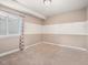 Bright bedroom with neutral striped walls, carpet, and large window, creating a calming space at 8099 Sabino Ln, Castle Rock, CO 80108