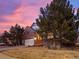 Beautiful brick home with a manicured front yard and mature trees, providing great curb appeal at 8099 Sabino Ln, Castle Rock, CO 80108