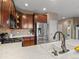 A kitchen view featuring a stainless steel refrigerator, brown cabinets and a white countertop with sink at 8099 Sabino Ln, Castle Rock, CO 80108