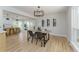 Modern dining area with light wood table, black chairs, and a stylish chandelier at 8875 E Phillips Pl, Centennial, CO 80112