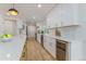 Modern kitchen with white cabinets, stainless steel appliances, and hardwood floors at 8875 E Phillips Pl, Centennial, CO 80112