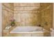 Stylish bathroom featuring a soaking tub with decorative tile surround at 275 S Harrison St # 409, Denver, CO 80209