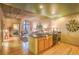 A full kitchen with stainless steel appliances, concrete ceilings, and hardwood floors at 275 S Harrison St # 409, Denver, CO 80209