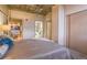 Well-lit primary bedroom with plush carpeting, closet, and access to a full bathroom at 275 S Harrison St # 409, Denver, CO 80209