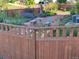 Landscaped backyard featuring a garden, patio, and well-maintained fence at 1799 Jade Ave, Brighton, CO 80603