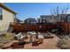 Backyard with a wooden fence, gardening area, and outdoor seating at 1799 Jade Ave, Brighton, CO 80603