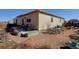 A house backyard with patio seating and metal planters at 1799 Jade Ave, Brighton, CO 80603