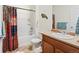 Full bathroom with a shower-tub combo and a colorful shower curtain for added decor at 1799 Jade Ave, Brighton, CO 80603