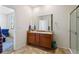 Bright bathroom with a double sink vanity, large mirror and glass-enclosed shower at 1799 Jade Ave, Brighton, CO 80603