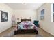 Cozy bedroom with neutral paint, two windows, and a comfortable bed with a wooden headboard at 1799 Jade Ave, Brighton, CO 80603