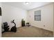 Bright bedroom with neutral walls, a window, and an exercise bike, perfect for fitness at 1799 Jade Ave, Brighton, CO 80603