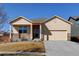 A cozy one-story home featuring stone accents, neutral colors, and a two-car garage at 1799 Jade Ave, Brighton, CO 80603