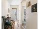 Bright hallway featuring wood floors, neutral paint, and artwork on the walls at 1799 Jade Ave, Brighton, CO 80603