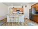 Bright kitchen featuring a breakfast bar and stainless steel appliances at 1799 Jade Ave, Brighton, CO 80603