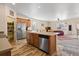 Open kitchen featuring stainless steel appliances, island with sink, and pantry at 1799 Jade Ave, Brighton, CO 80603