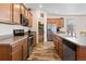 Stylish kitchen equipped with stainless steel appliances, wood cabinets, and a pantry at 1799 Jade Ave, Brighton, CO 80603