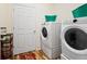 Laundry room with modern appliances, including a front-load washer and dryer set at 1799 Jade Ave, Brighton, CO 80603