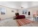 Spacious living room with multiple windows that provide lots of natural light, along with a dining table at 1799 Jade Ave, Brighton, CO 80603